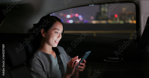 Woman use of mobile phone on car at night © leungchopan