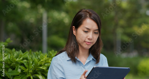 Woman look at tablet computer at outdoor