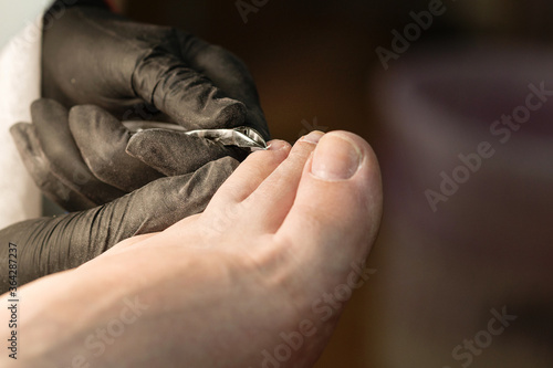 Master chiropody removes the cuticle. Spa. Concept body care. © Vagengeim