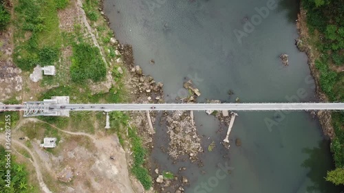 Top view of the Opak river with a suspension bridge crossing the river. Yogyakarta Indonesia photo