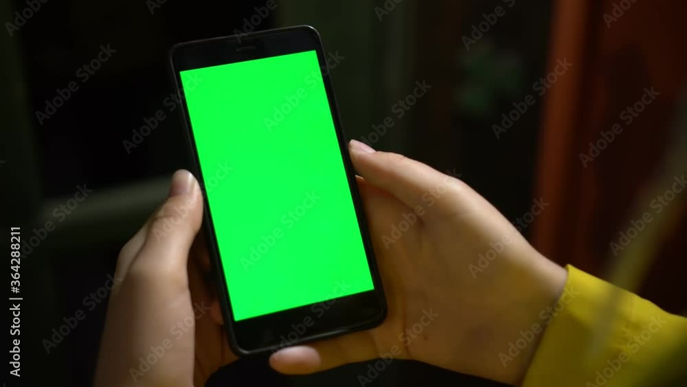 Close up of a woman's hand holding a mobile telephone with a vertical ...