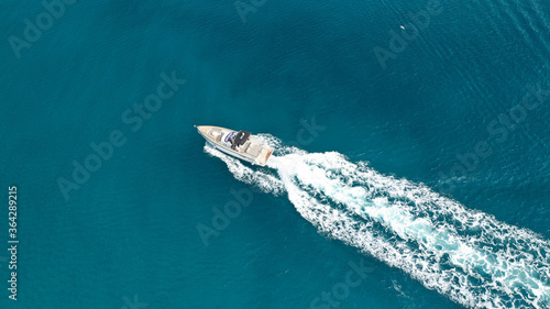 Aerial drone ultra wide photo of rigid inflatable speed boat cruising in deep blue Aegean sea, Greece © aerial-drone