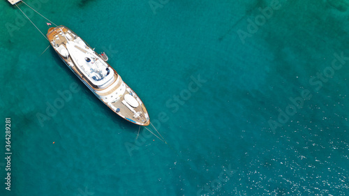 Aerial drone photo of yacht - boat with wooden deck anchored in tropical exotic paradise with turquoise open sea © aerial-drone