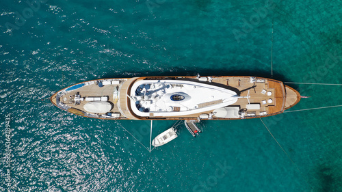 Aerial drone photo of large yacht - boat anchored in tropical exotic paradise bay with emerald open ocean © aerial-drone