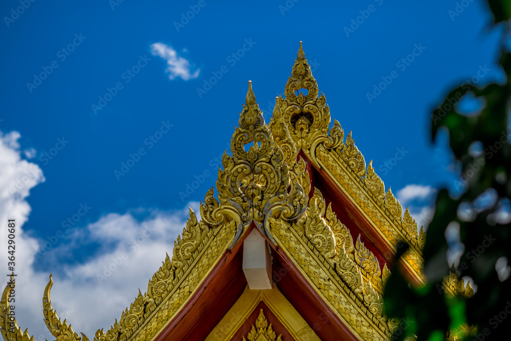 Fototapeta premium Blurred abstract background of sculptures seen at temples or religious tourist sites (Phaya Nak, Buddha statues) within Wat Pa Phu Kon in Udon Thani, Thailand