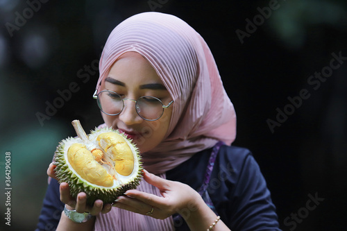 Asia woman holding durian fruit photo