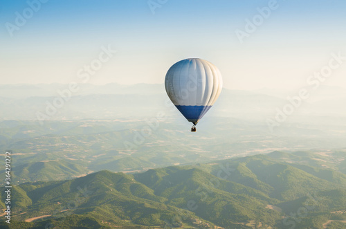 hot air Balloon Flying over the mountains