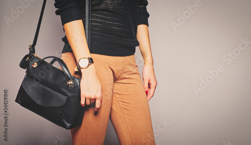 Girl is caring her handbag on her shoulder