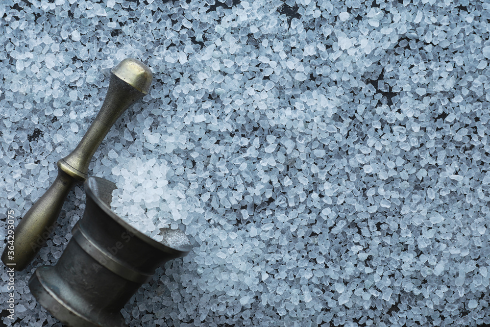 Large sea salt. Spice. Mortar and pestle for grinding.