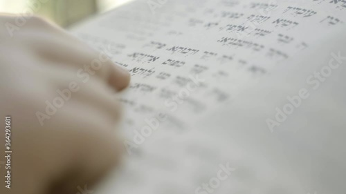 A boy reading a Hebrew holy book, Follows the reading with his finger, Jewish Book of Prayer Book
Super close up shote photo