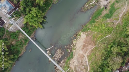 Top view of the Opak river with a suspension bridge crossing the river. Yogyakarta Indonesia photo