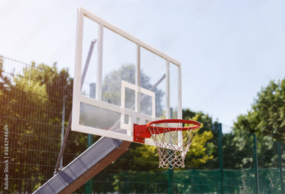 Basketball backboard with empty basket at outdoor sports arena, empty space