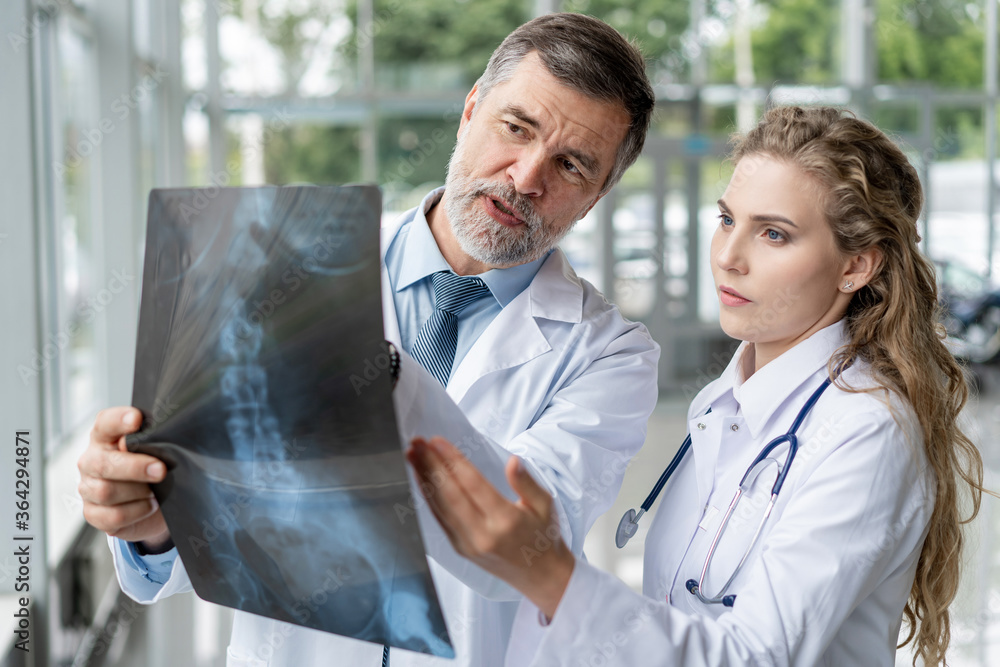 Doctors analyzing an x-ray in a meting.