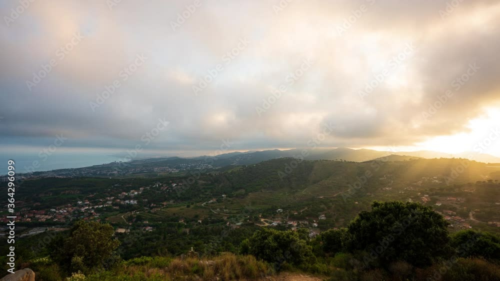 Time-lapse of the sunset on the Barcelona el Maresme coast. We can see the exit motorway to the north of Barcelona. And the towns of Alella, Masnou, Montgat, Badalona and in the background Barcelona. Time-lapse of the sunset on the Barcelona el Maresme coast. We can see the exit motorway to the north of Barcelona. And the towns of Alella, Masnou, Montgat, Badalona and in the background Barcelona.