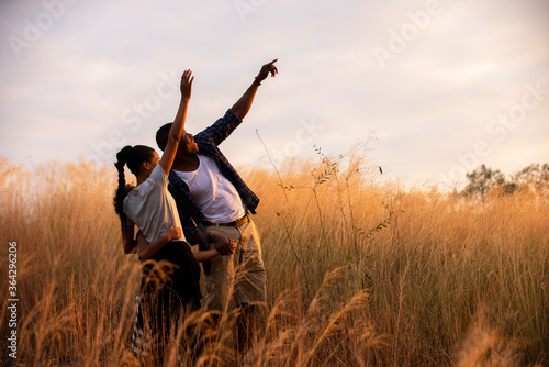 african family enjoy together on meadow with sunlight at nature park