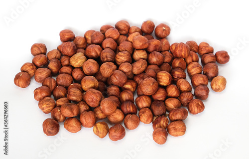 roasted hazelnuts in a bucket on a white background