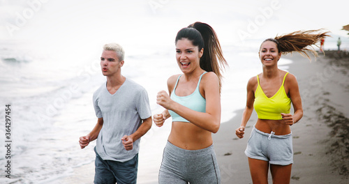 Group of sport people jogging, running on the beach © NDABCREATIVITY