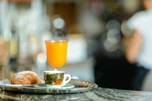 Espresso coffee, orange juice.  and custard pastry cream croissant for a caloric breakfast or coffee break, selective focus. bokeh, shallow dof photo