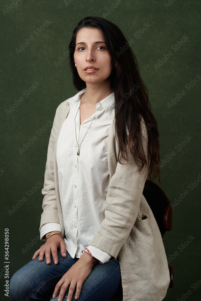 Young woman sitting in armchair at home. Young woman sitting in armchair at home.