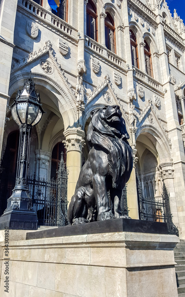 Sculpture of a lion a front of Hungarian parliament. Budapest.