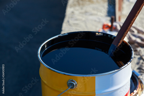 bitumen in a metal barrel photo