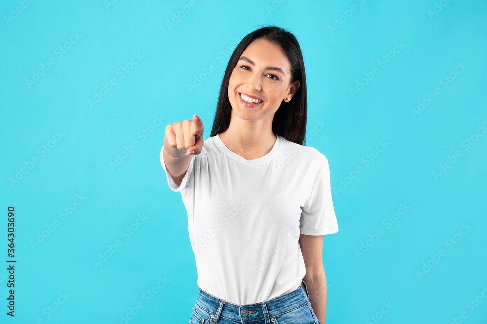 Happy woman posing and pointing at you Happy woman posing and pointing at you