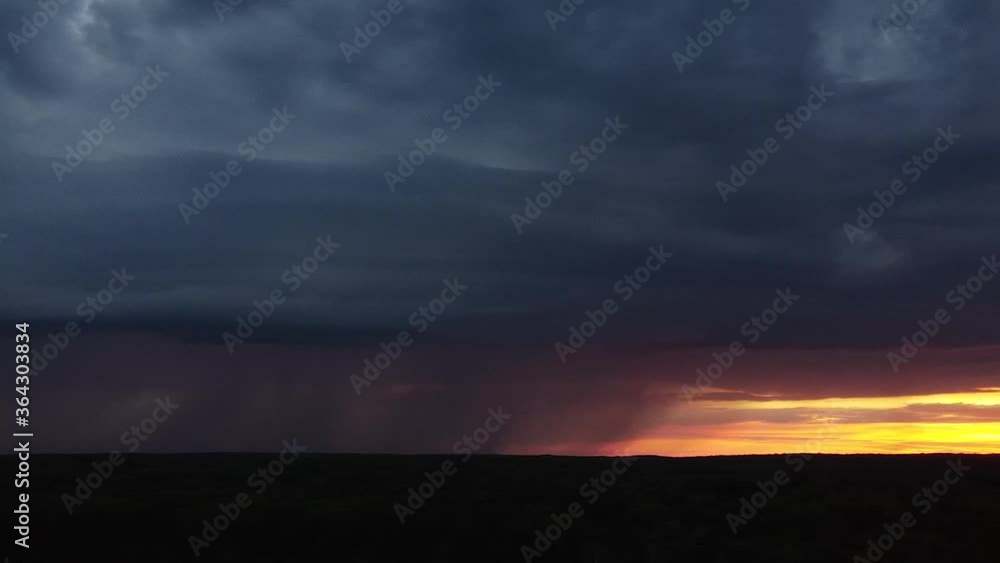 Aerial photography. Clear lightning and against the sunset sky. It's raining from a thundercloud. Electric flashes light up the sky Aerial photography. Clear lightning and against the sunset sky. It's raining from a thundercloud. Electric flashes light up the sky