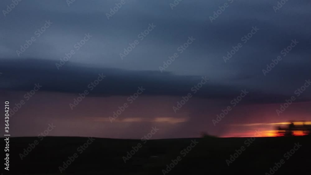 Aerial photography. Clear lightning and against the sunset sky. It's raining from a thundercloud. Electric flashes light up the sky Aerial photography. Clear lightning and against the sunset sky. It's raining from a thundercloud. Electric flashes light up the sky