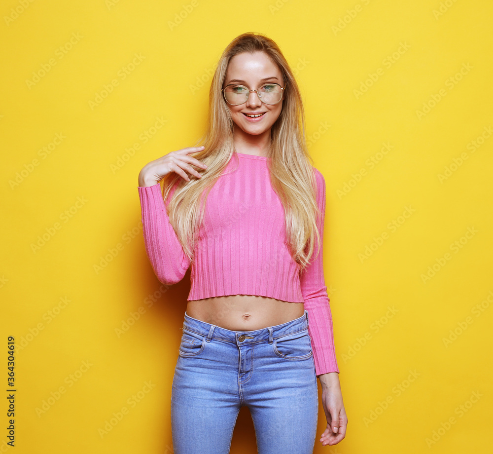 portrait of a smiling blond woman with long hair, wearing casual clothes and eyeglasses portrait of a smiling blond woman with long hair, wearing casual clothes and eyeglasses