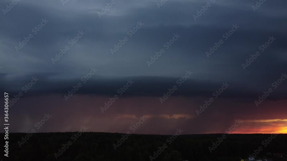 Aerial photography. Clear lightning and against the sunset sky. It's raining from a thundercloud. Electric flashes light up the sky Aerial photography. Clear lightning and against the sunset sky. It's raining from a thundercloud. Electric flashes light up the sky
