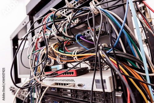 Server room with computers for internet. Network cables connected to switches.