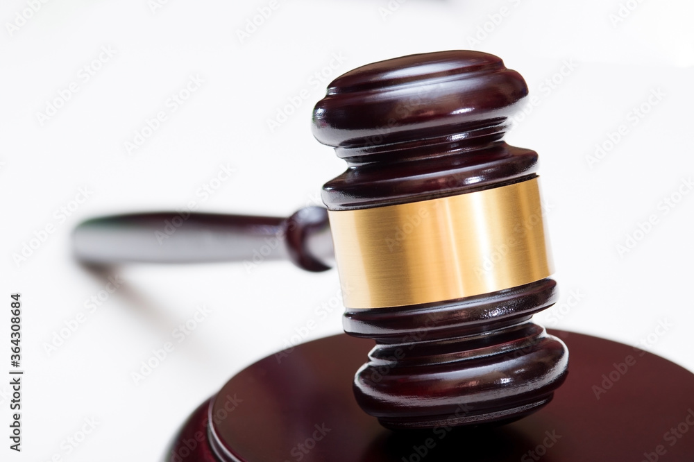 A wooden judge's hammer with a metal ring and a soundboard with perspective isolated on a white background. A wooden judge's hammer with a metal ring and a soundboard with perspective isolated on a white background.