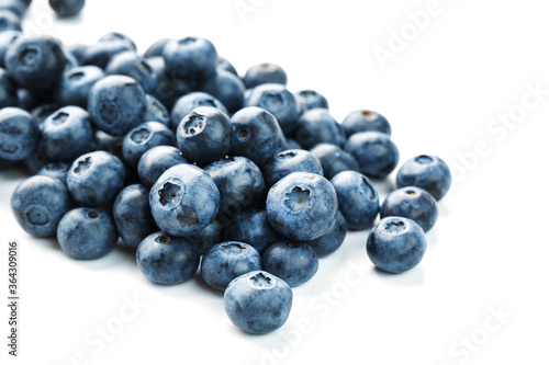 Blueberries are scattered on a white background. Free space, isolate. Studio light.