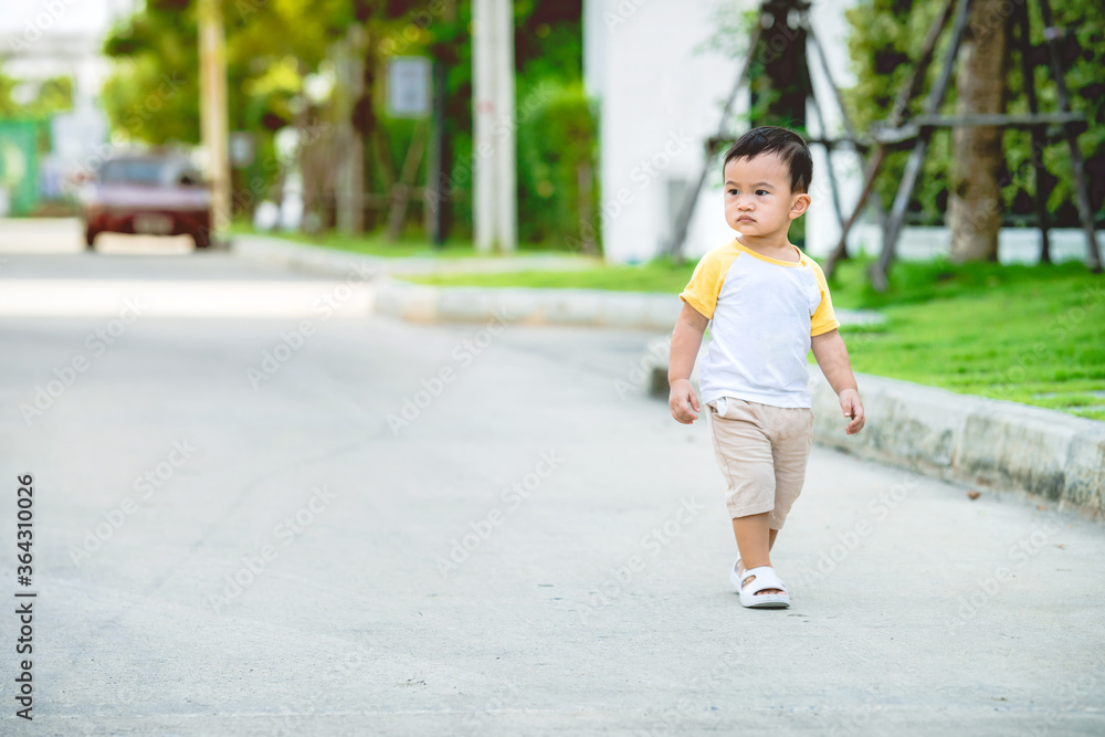 Asian baby boy is walking on street, copy space for writing articles. Asian baby boy is walking on street, copy space for writing articles.