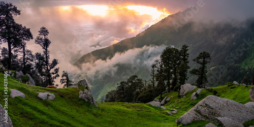 Mesmerizing view of cloudy red sunset sky background during sunset enroute to Triund trekking trail from Mcleodganj, Dhramshala, Himachal Pradesh, India.