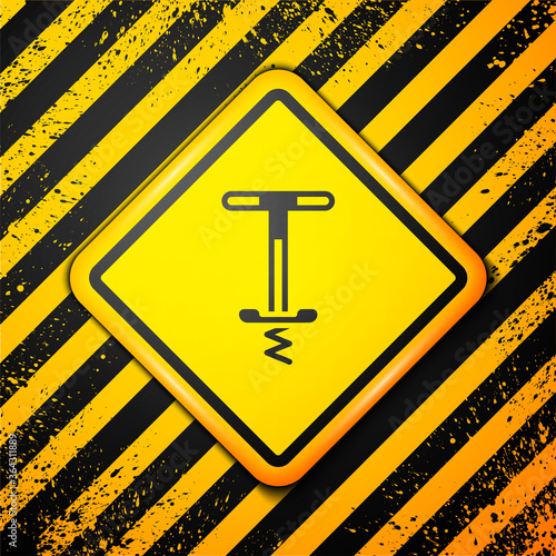 Black Pogo stick jumping toy icon isolated on yellow background. Warning sign. Vector. photo