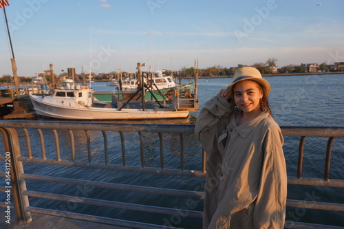 young woman sitting on a pier © Edymar