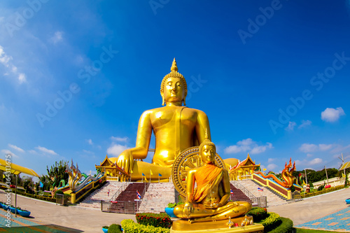 Beautiful of Large golden sitting Buddha statue with background of blue sky at Wat Muang  temple  Ang Thaong Thailand