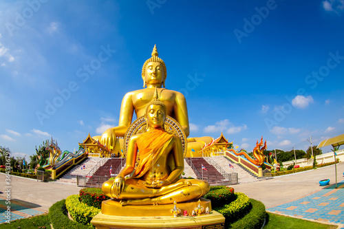 Beautiful of Large golden sitting Buddha statue with background of blue sky at Wat Muang  temple  Ang Thaong Thailand