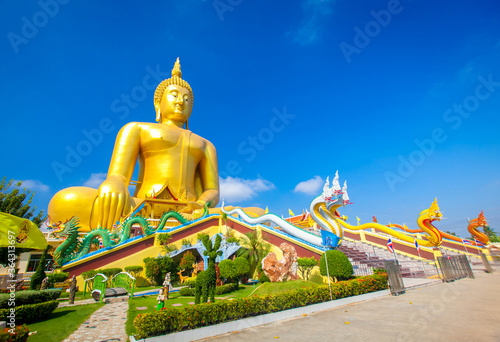 Beautiful of Large golden sitting Buddha statue with the background of blue sky at Wat Muang  temple,Ang Thaong, Thailand