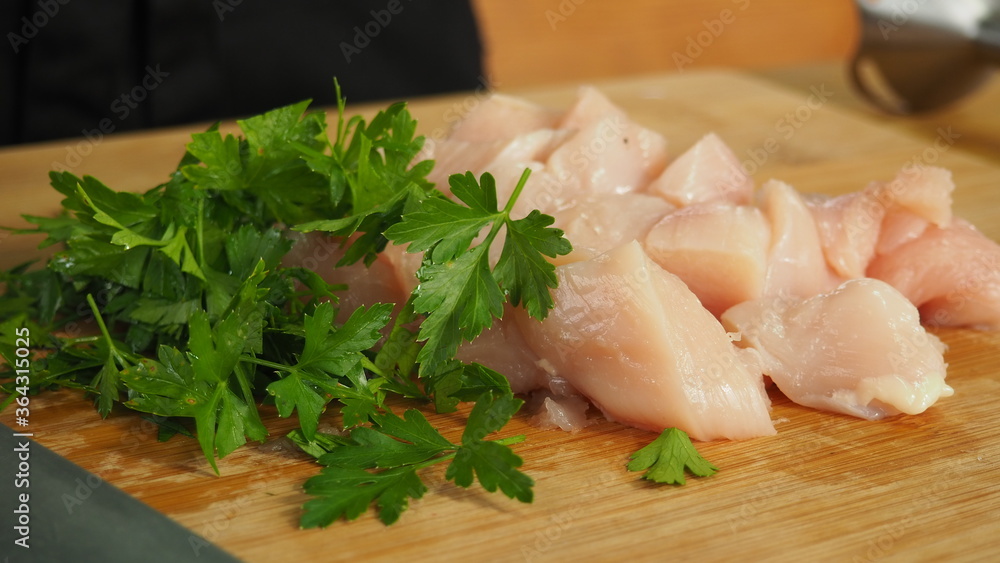 tender sliced chicken fillet on a wooden Board with herbs tender sliced chicken fillet on a wooden Board with herbs