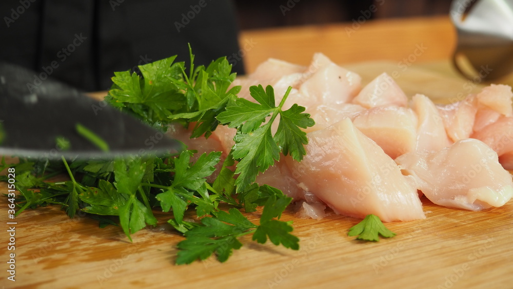 tender sliced chicken fillet on a wooden Board with herbs tender sliced chicken fillet on a wooden Board with herbs