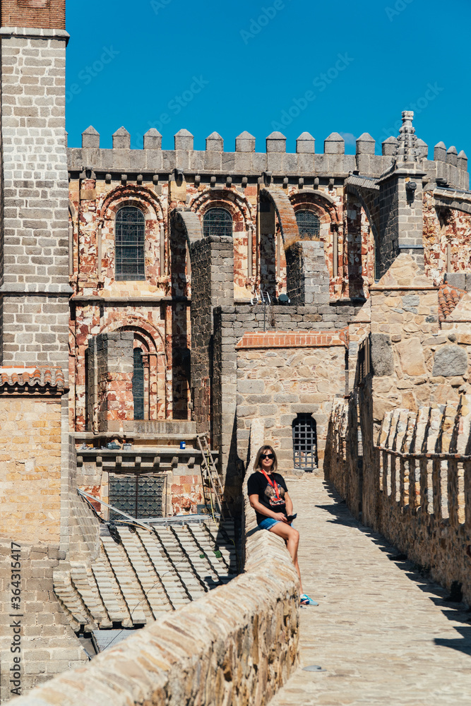 Woman tourist walks on the fortress of the city of Avila in Spain