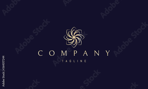 Vector golden logo on which an abstract image of a beautiful flower with petals.