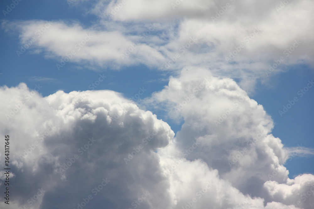 Beautiful Cumulus clouds on a blue sky on a Sunny summer day close up Beautiful Cumulus clouds on a blue sky on a Sunny summer day close up