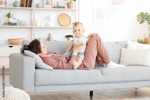 Millennial Mom Spending Time With Her Cute Toddler Son At Home,