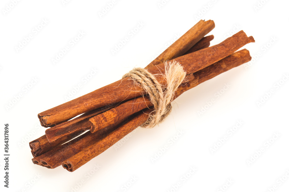 Cinnamon sticks heap isolated on white