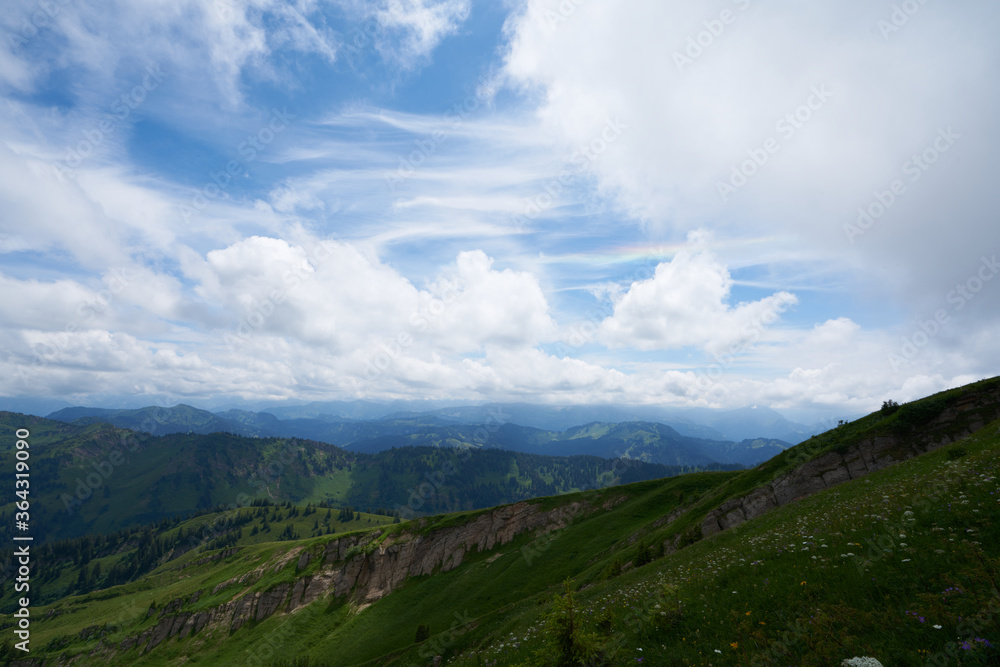 rainbow in the clouds over a mountain landscape in the bavarian alps