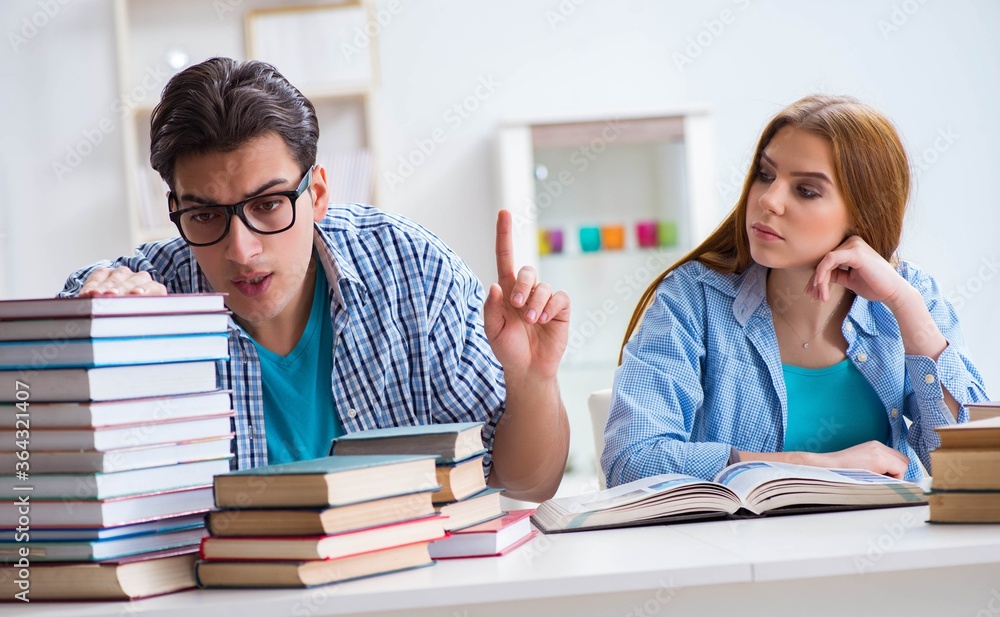 Pair of students studying for university exams Pair of students studying for university exams