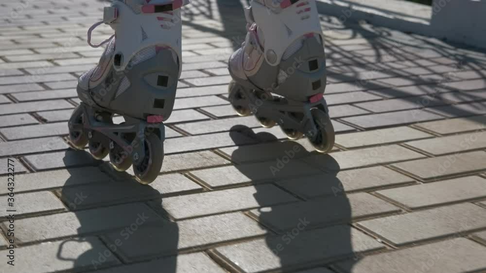 Child roller skating. Child's feet on rollers. Child roller skating. Child's feet on rollers.